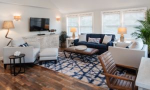 Edgartown Martha's Vineyard Luxury Suite with Blue Couch and Decorative Chairs In Front of Entertainment Center